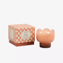Load image into Gallery viewer, A pink Boxed Tulip Glass Candle is lit and sits next to its orange-and-white decorative box labeled "Cactus Flower." The candle is housed in a matching flower-shaped pink glass container.