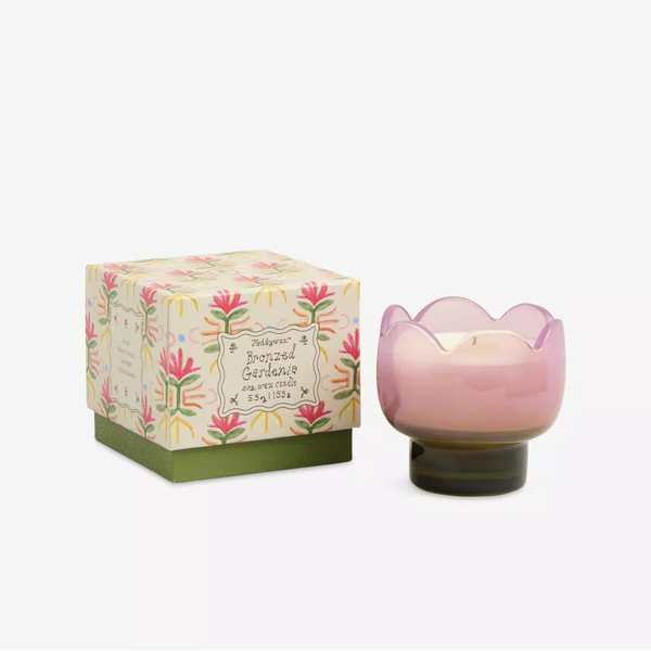 A Boxed Tulip Glass Candle by Paddywax, in a pink flower-shaped holder with a floral box labeled Bronzed Garden, features green, pink, yellow accents and the fresh scent of Cactus Flower.