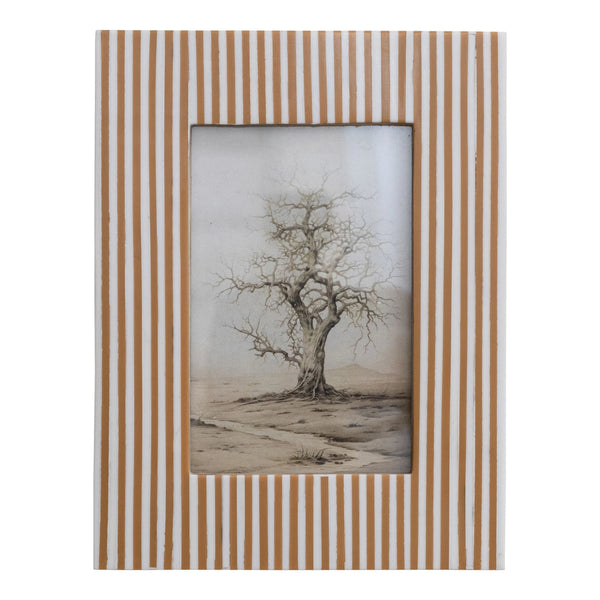 The 4x6 Resin Striped Frame features vertical tan and white stripes and displays a black and white drawing of a solitary leafless tree on a barren landscape.